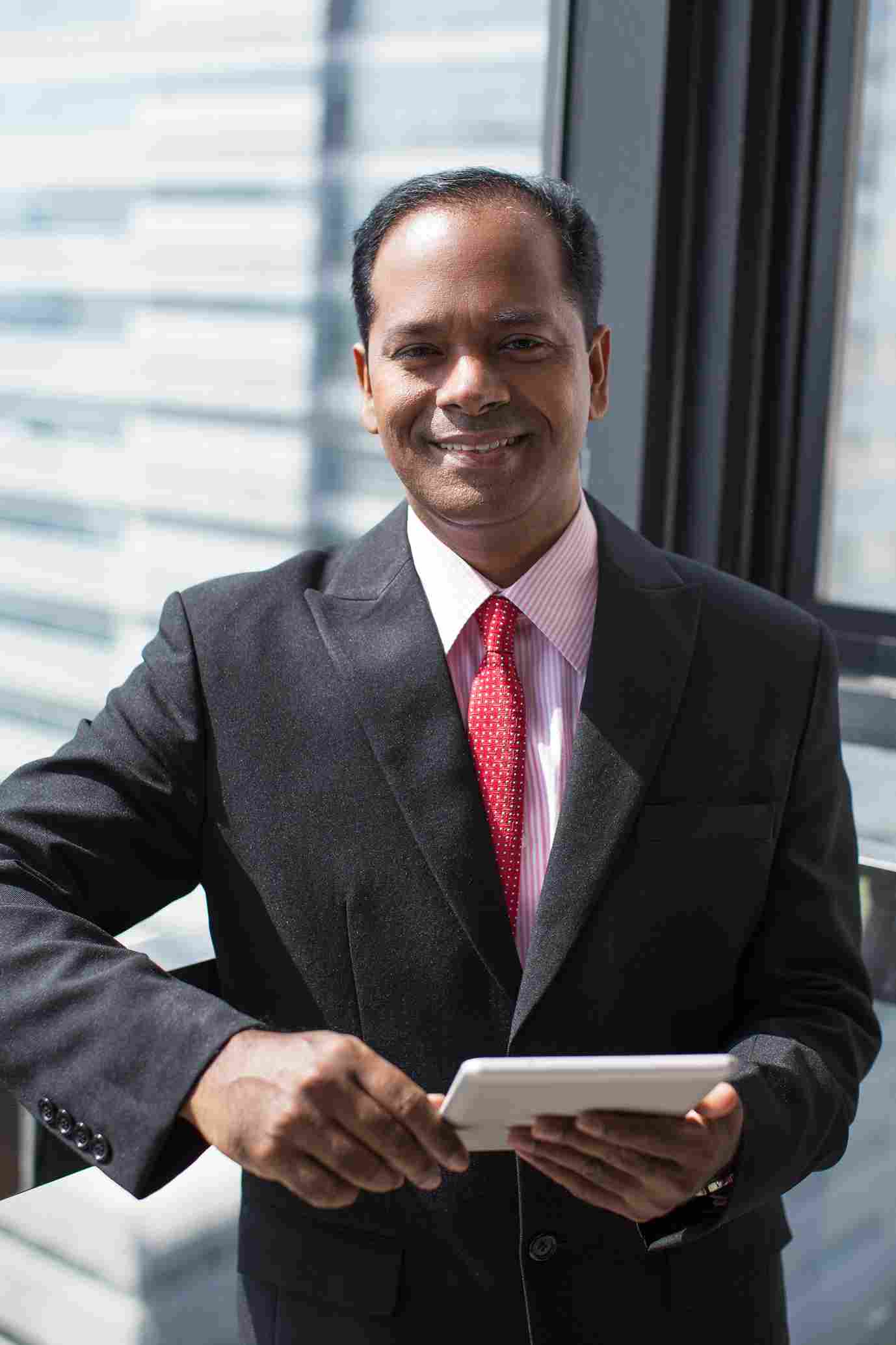 successful-indian-businessman-with-digital-tablet_11zon